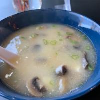 MISO SOUP · Miso based soup served with mushrooms, scallions, tofu and onion crunch
