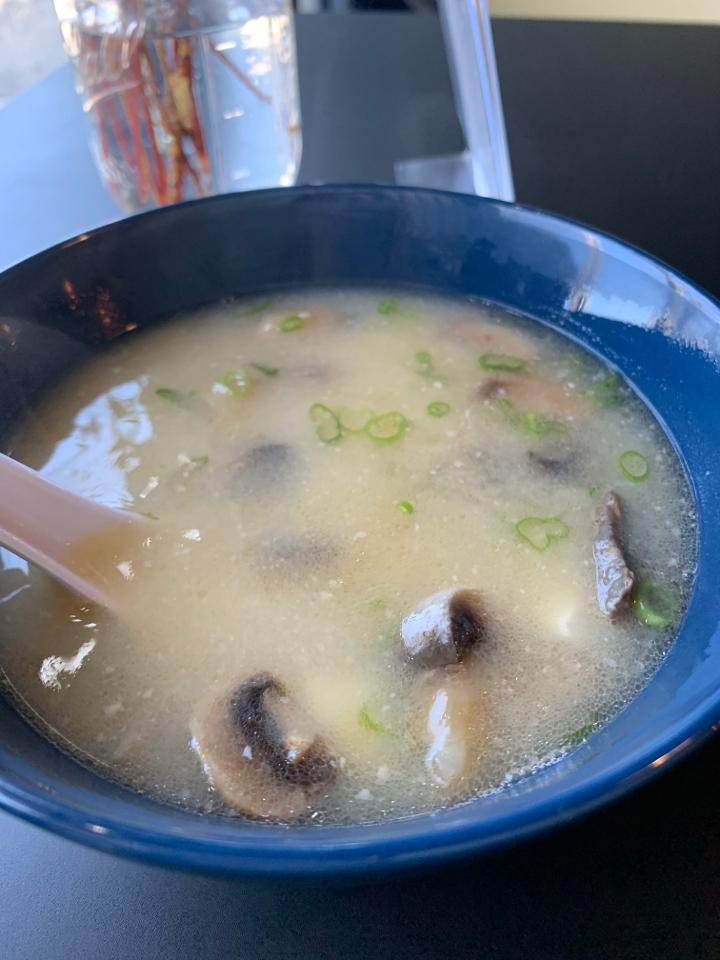 MISO SOUP · Miso based soup served with mushrooms, scallions, tofu and onion crunch