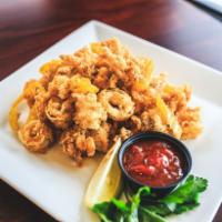 Spicy Calamari · Fried and tossed with Cajun butter and banana peppers, served with a side of Oscar's own coc...