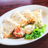Chicken Quesadilla · Flour tortillas stuffed with chicken, cheese, peppers and jalapenos and served with sour cre...