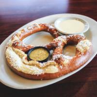 Bavarian Pretzel · Individual pretzel served hot with our own queso cheese sauce and spicy beer mustard.