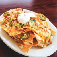 Cheesy Nachos · Fresh tortilla chips topped with shredded cheddar, mozzarella and provolone, sour cream, pic...