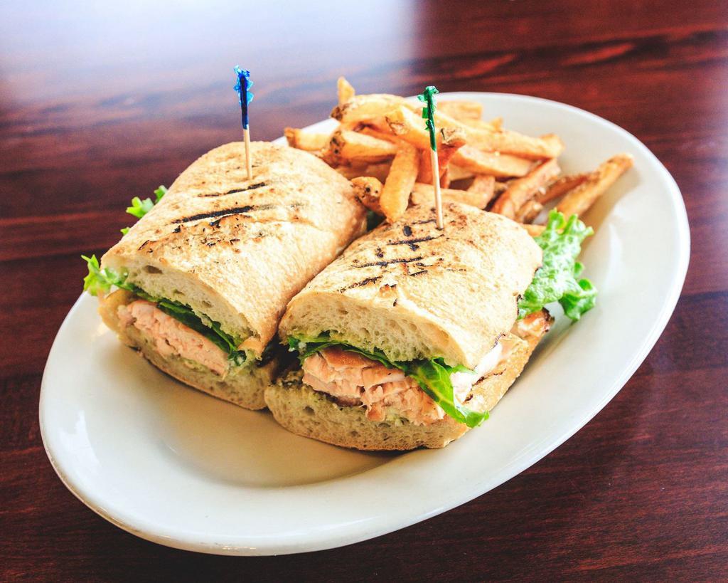 Wood-Grilled Salmon Sandwich · Grilled salmon topped with crumbled bleu cheese, lettuce and tomato with cucumber mayo and a side of French fries. Served on grilled ciabatta bread.