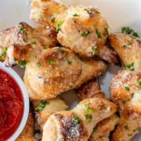 8 Piece Garlic Knots · Garlic Knots: Our pizza dough hand crafted into knots tossed in garlic, park cheese and pars...