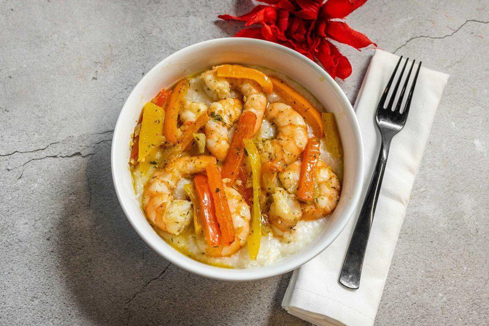 Shrimp and Grits  · Shrimp and Tri Colored Peppers Sauteed  in Garlic Butter Sauce served over Creamy Grits.