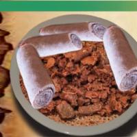 5. Tibs Firfir · Strips of rolled injera mixed with cubed sauteed beef, onion and jalapeno, seasoned with her...