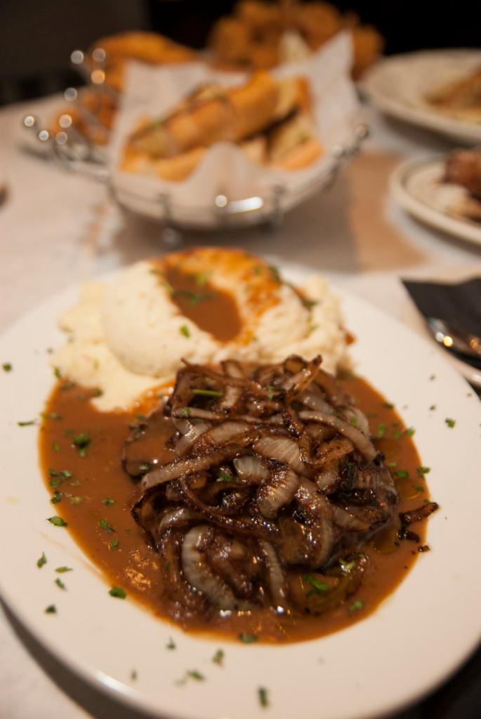 Hamburger Steak · Smothered with gravy and onions.