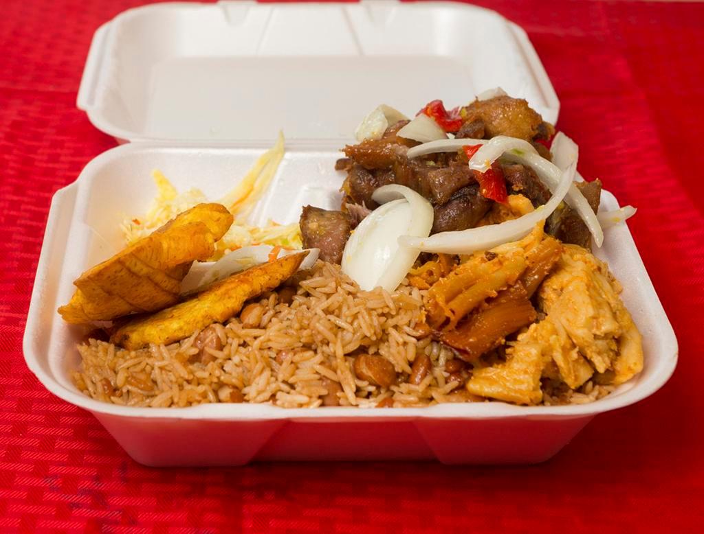 Grio Complet · Served with fried pork chunks and fried plantains with choice of rice with beans or white rice with red or black beans and salad (lettuce and tomatoes).