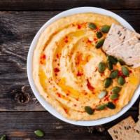 Hummus · A large portion of hummus comes with one pita bread on the side.