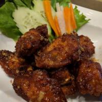 8. Hippie Chicken Wings · Deep fried chicken wings sauteed with sweet garlic sauce and topped with crispy basil.