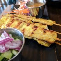 9. Gai Satay( 3 skewers) · Marinated chicken skewers, grilled and served with peanut sauce and cucumber salad.
