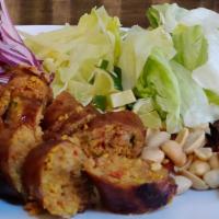 11. Sai Ua · Northern Thailand herb pork sausage, grilled and served with peanuts, ginger, sliced red oni...
