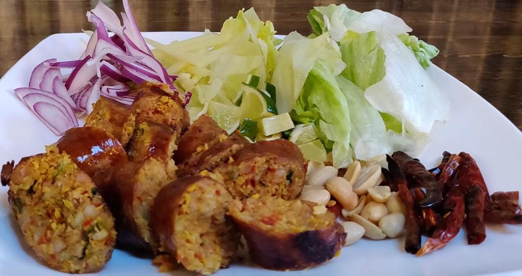 11. Sai Ua · Northern Thailand herb pork sausage, grilled and served with peanuts, ginger, sliced red onion and lime.
