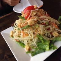 2. Som Tum Goong Yang Salad · Shredded green papaya salad with chili, tomatoes, lime dressing and ground peanuts topped wi...