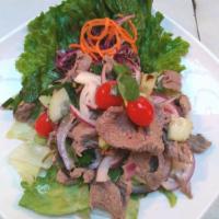 4. Beef Salad · Grilled beef, chili, lime, tomato, cucumber, red onion, cilantro and scallion. Mixed with sp...