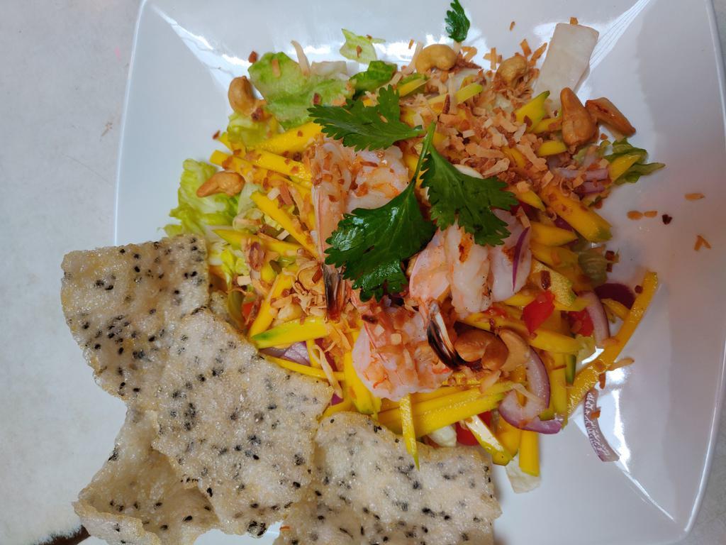 Mango Salad · Diced Mango,grilled shrimp,roasted coconut,bell peppers,tomatoes,onion,cashew nuts,lime dressing,Served with crispy sesame crackers