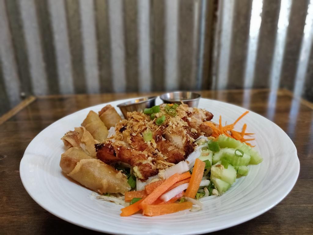 Rice noodles salad  chicken  · Grilled chicken with cold rice noodles,mixed salad,cucumber,bean sprouts Carrots,cilantro,green onion,basil,mint,deep fried vegetable roll pieces and topped with ground peanut .Served with homemade sauce.