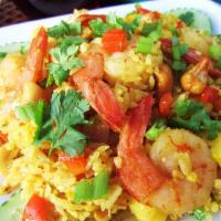2. Kow Pad Sub Pa Rot · Fried rice with pineapple, choice of meat, yellow curry powdered onion, tomato, peas & carro...