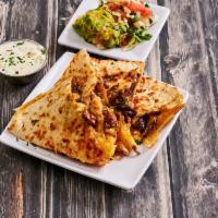 Steak Quesadilla · A large flour tortilla grilled with melted cheese served with lettuce, tomatoes, sour cream ...