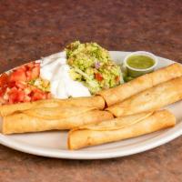 Tijuana Tacos · Chicken or beef wrapped in a corn tortilla served with lettuce, tomatoes, sour cream and gua...