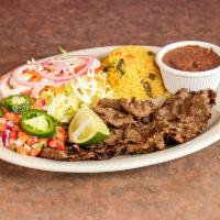 Carne Asada · Grilled steak served with rice, beans and salad.