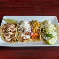 Crispy Fried Fish Taco · Pescado frito, with a lime cabbage and cilantro slaw and topped with pineapple pico de gallo. 