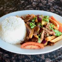 Lomo Saltado · Stir-fried chicken or beef, onions, tomatoes and french fries. Served with white rice.