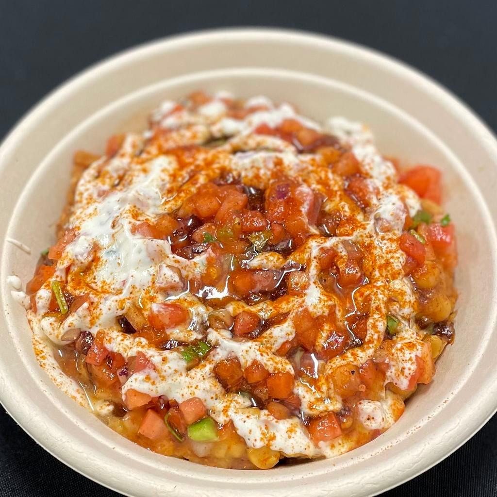 Samosa Chaat · A South Asian snack mainstay!
Samosa topped with Chickpeas, Pico, Tamarind Chutney, Mint Yogurt chutney. Finished off with a house Chaat Masala which gives it a salty, tangy flavor, with just an ever so slight spice. Brings it together Perfectly!