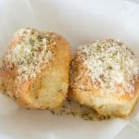 Garlic Bread · Dough rolled up and topped with a mixture of garlic oil and Parmesan cheese on top.
