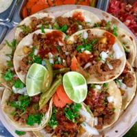 Taco Regular · Carne, cilantro, cebolla, and salsa. Meat, cilantro, onions, and salsa.