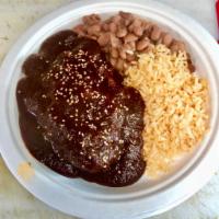  Mole · Platillo con mole negro, pollo, arroz, frijoles y tortillas. Black mole sauce, chicken, rice...