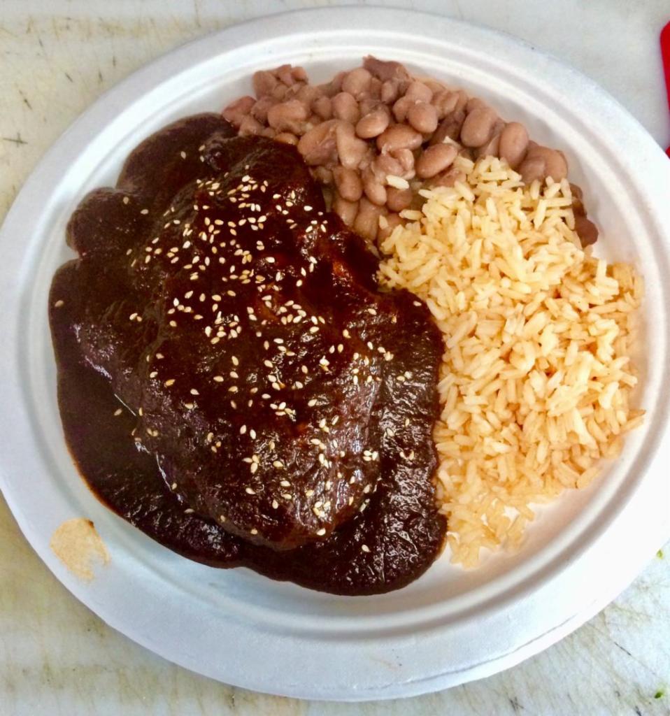  Mole · Platillo con mole negro, pollo, arroz, frijoles y tortillas. Black mole sauce, chicken, rice, beans, and tortillas.