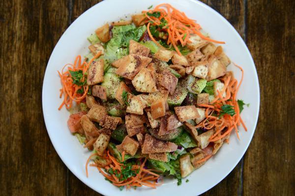 Fattoush Salad · Romaine hearts, tomatoes, cucumbers, carrots, radishes, sliced onion, pita chips, spices and house dressing.
