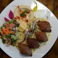 Kibbeh · The cracked wheat outer shell, filled with seasoned ground beef, onions, and pine nuts.