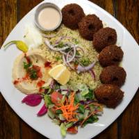 Falafel Plate · Falafel made of garbanzo and fava beans served with onions, tomatoes and dressed in tahini.