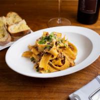 Fettucine alla Bolognese · Home made fettuccine pasta served with a classic bolognese sauce.