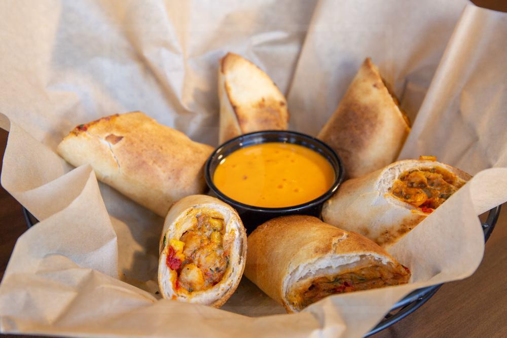 Southwest Eggrolls · Crispy egg rolls loaded with chicken, cheese, black beans, corn, and jalapenos. Served with boom boom sauce for dipping.