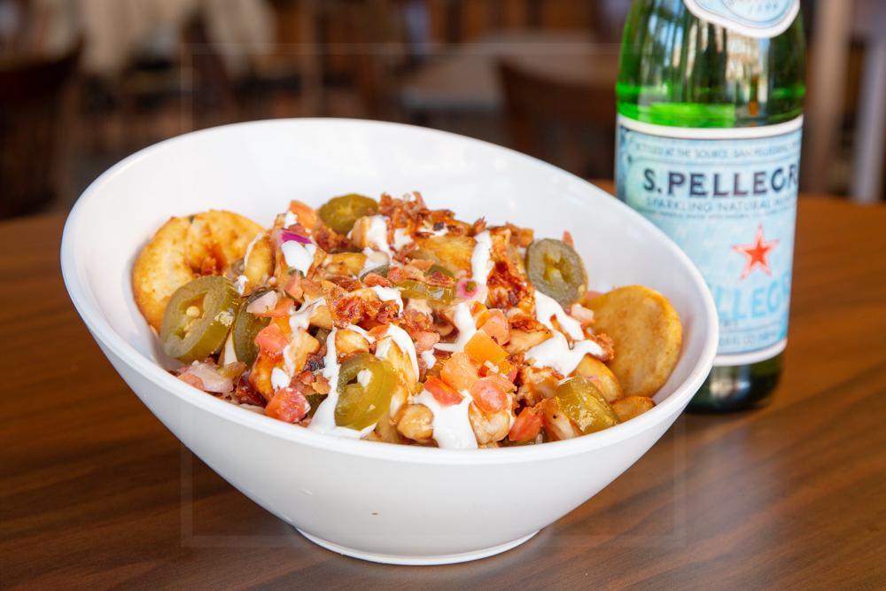 Loaded Sidewinders · Crispy beer-battered potatoes with housemade beer cheese. Topped with BBQ chicken, sour cream, bacon, jalapenos, and pico de gallo.