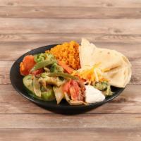 Fajitas · Fajitas include sizzling platter of vegetables, Mexican rice, refried beans, guacamole, sour...