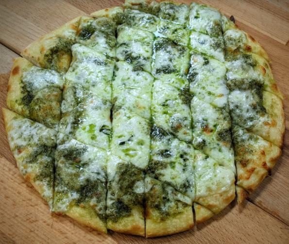 Pesto Pizza Chips · Fresh, thin, hand-tossed dough topped with basil pesto sauce (made with basil leaves, fresh garlic, pine nuts and olive oil), whole milk mozzarella and Monterey Jack cheese blend, and Italian seasoning.