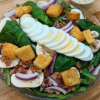 Spinach Salad · Fresh spinach, red onions, mushrooms, hard-boiled eggs, bacon, oven-baked croutons and poppy...