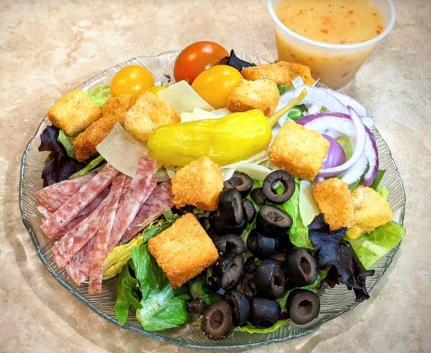 Antipasto Salad · Crispy greens, salami, red onions, black olives, pepperoncini peppers, tomatoes, oven-baked croutons, parmesan cheese and Italian dressing.