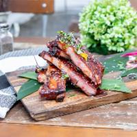 Full Slab Sticky Sweet Ribs · Smoked St. Louis ribs glazed with a sweet Asian sauce served with sesame seeds, scallions an...