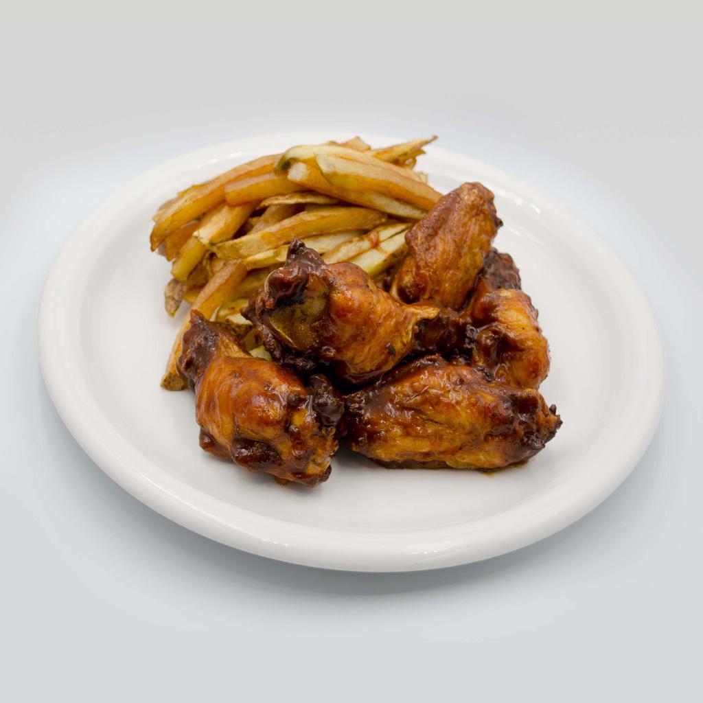 Trini Style Jerk Chicken Wings · Try our version of Jerk Chicken Wings, we soak our wings in green seasoning, with a twist of jerk spices, fried to a golden brown, tossed in our jerk bar-b-que sauce, served with any one of our made from scratch sauces and with a side of fries.