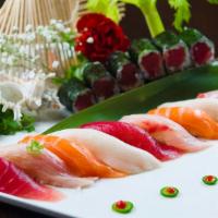 Sushi Deluxe · 9 pieces of assorted sushi with one tuna roll. Served with soup or salad.