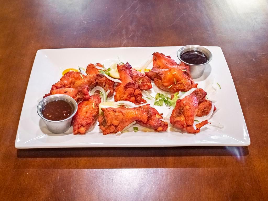 Chicken Wings · Jumbo chicken wings marinated in our house tandoori marinate. Served fried or baked in the tandoor and tossed with one of our house sauces.