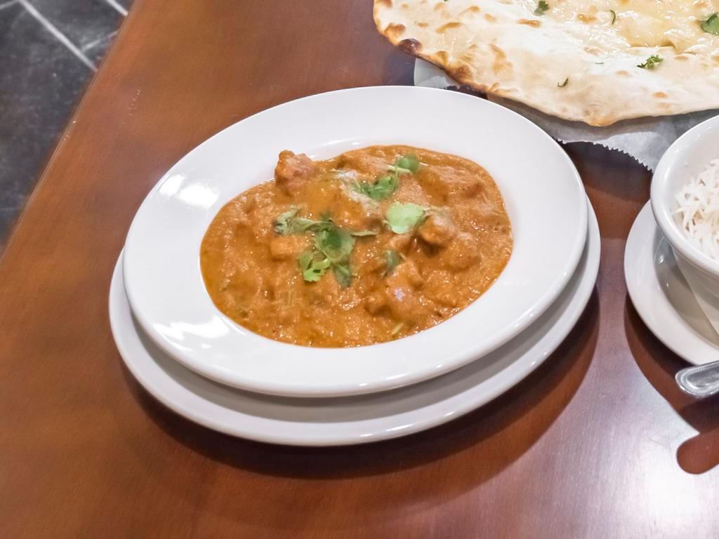 Butter Chicken · Chicken tenders barbecued and shredded, simmered in a tomato based sauce and spices.