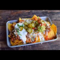Morelia Nachos · Tortilla chips, refried beans, chicken and ground beef, melted cheese, sour cream, jalapenos...