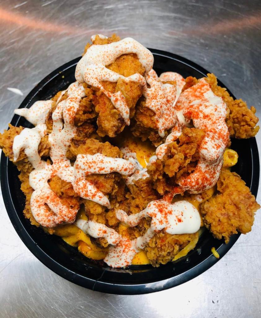 Mac-N-Chicken Bowl · Bed of our homemade mac and cheese topped with our hand battered fried chicken breast and signature sauce.