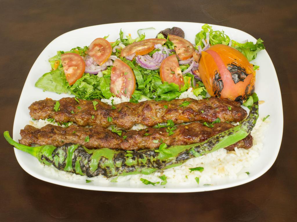 Adana Kebab · Ground lamb flavored with red bell peppers slightly seasoned with paprika and grilled deliciously on skewer.